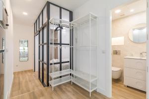 a glass shower in a bathroom with a toilet at Arturo Soria Apartments2 in Madrid