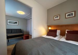 a bedroom with a large bed and a couch at Hotell Funäsdalen in Funäsdalen +52 photos