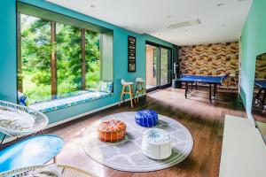 a room with a ping pong table and chairs at AMO 54 by Hakuba Hospitality Group in Hakuba