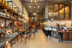 a large room with tables and chairs in a store at House of Machine Boutique Hotel in Bangkok