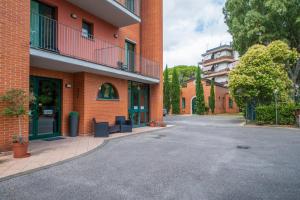 an empty street in front of a brick building at Casa Betania in Pisa