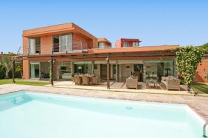 a house with a swimming pool in front of a house at Top Salobre Villas by VillaGranCanaria in Salobre