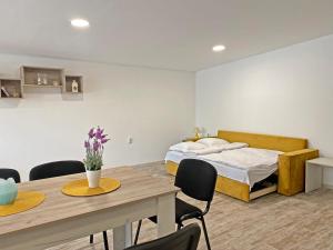 um quarto com uma cama, uma mesa e cadeiras em Di Mare Holiday Apartments em Kranevo