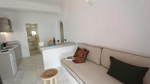 a living room with a couch and a kitchen at Aegean Dream Apartments in Tinos