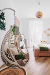 silla mecedora en una habitación con cama en New Jungle & Charming Flat - zona De Angeli en Milán