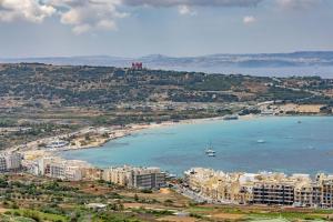 an aerial view of a city and a beach at Dome Sunset Views Apartment in Mellieħa