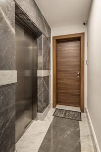 a hallway with a door and a tile floor at Dome Sunset Views Apartment in Mellieħa