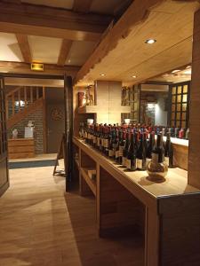 a bunch of bottles of wine sitting on a counter at La Sapinière in Saint-Lary-Soulan