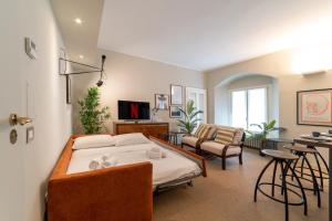 a bedroom with a bed and a living room at Luxury Apartment Brera - Centro in Milan