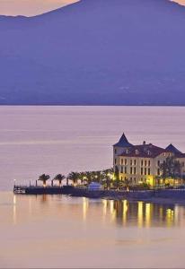 a large building on the shore of a body of water at Saint George Hotel in Loutra Edipsou