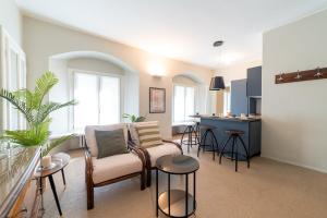 a living room with a couch and chairs and a kitchen at Luxury Apartment Brera - Centro in Milan