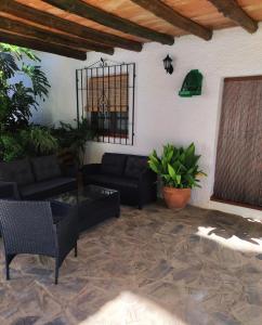 a living room with a couch and a table and chairs at CORTIJO LALO in Órgiva
