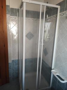 a shower with a glass door in a bathroom at Trilocale Piazza Italia Orosei - IUN Q5292 in Orosei