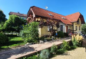 a house with a garden in front of it at Privat ALMA in Nová Lesná