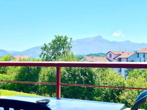 einen Tisch auf dem Balkon mit Bergblick in der Unterkunft Caporizon-Baillenia-T1 Vue Montagne - Piscine St Jean de luz in Saint-Jean-de-Luz