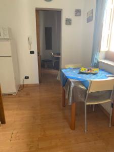 a table with a blue table cloth on it in a room at Casa di Tony in Trapani