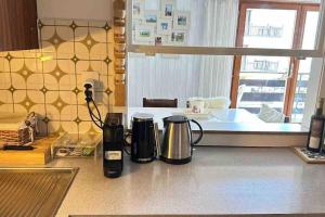 two coffee makers sitting on a counter in a kitchen at Sunny mountain view apartment in town by Jolidi in Nendaz