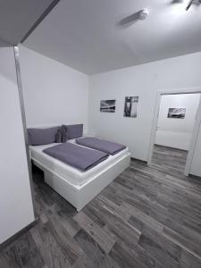 a bedroom with a bed and a wooden floor at Waldluft Apartments in Heidenreichstein