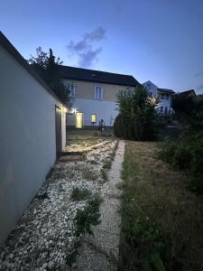a house with a gravel path in front of a house at Waldluft Apartments in Heidenreichstein