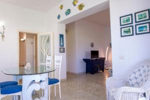 a dining room with a glass table and chairs at BouganVilla in Polignano a Mare
