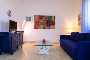 a living room with a blue couch and a table at BouganVilla in Polignano a Mare