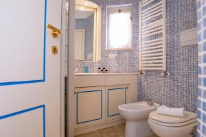 a bathroom with a toilet and a sink and a mirror at BouganVilla in Polignano a Mare +83 photos