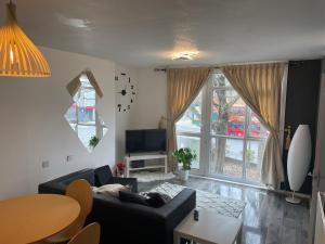 a living room with a couch and a table at Two bedroom flat in London near the 02 in London