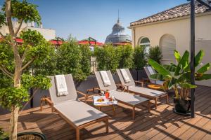 a row of chairs on a rooftop patio at Palacio Gran Vía, a Royal Hideaway Hotel in Granada