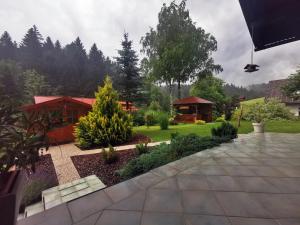 a garden with a gazebo in the background at Lookout Resort apartments in Rovte