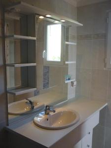 a bathroom with two sinks and a mirror at Soleil De Camargue in Le Sambuc