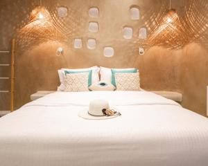 A bed or beds in a room at AMMOS at AmazeU Suites Naxos