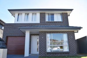 a red brick house with a garage at Elegant & Convenient New House at Leppington in Leppington