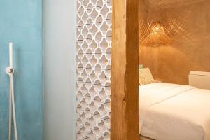 A bed or beds in a room at AMMOS at AmazeU Suites Naxos