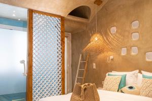 A bed or beds in a room at AMMOS at AmazeU Suites Naxos