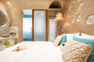 A bed or beds in a room at AMMOS at AmazeU Suites Naxos