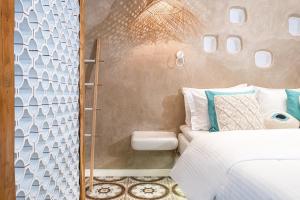 A bed or beds in a room at AMMOS at AmazeU Suites Naxos