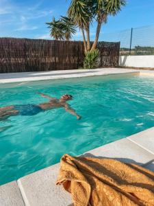 a man swimming in a swimming pool at Quinta Amarela - B&B in Nazaré