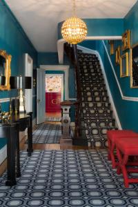 a room with blue walls and a staircase with a red bench at Gilded in Newport