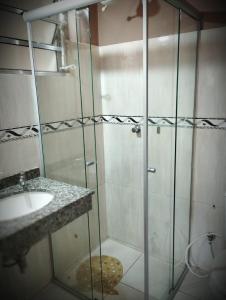 a bathroom with a shower and a sink at Novohotel Express in Santana do Livramento