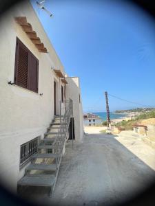 a stairway to a building with the ocean in the background at Casa panorama Sciacca in Sciacca