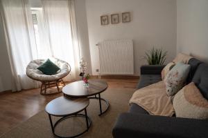 a living room with a couch and a table at Le Luma in Colmar