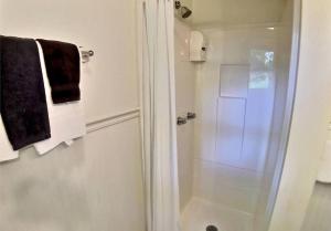 a bathroom with a shower with a glass door at Suite Memories #5/ Oak Crest in Eureka Springs