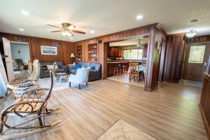 a living room with a couch and a table and chairs at Beautiful home on Lake Michigan, near Escanaba 