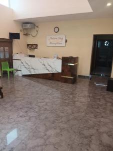 a large room with a marble floor and a counter at ANTARA STAY in Coimbatore +49 photos