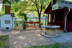 a red bench sitting in front of a building at AppleGarden in Debrecen