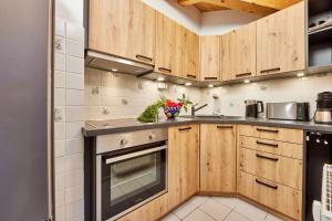 a kitchen with wooden cabinets and a stove at Haus Alpklang in Garmisch-Partenkirchen