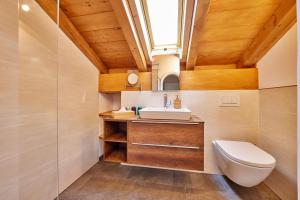 a bathroom with a toilet and a sink at Haus Alpklang in Garmisch-Partenkirchen