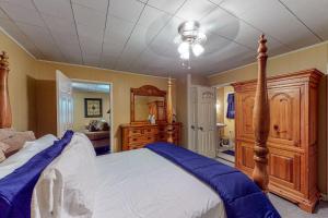 a bedroom with a large bed and a dresser at Keepin' it Reel in Avinger