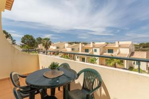a table and chairs on a balcony with a view at Glenridge Resort By Albufeira Rental in Albufeira
