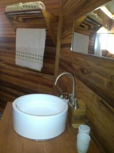 a bathroom with a sink in a cabin at Tierra Madre Eco Lodge in Los Andes